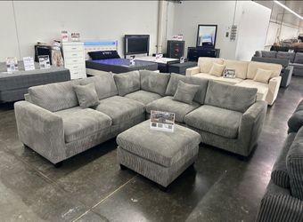 Grey corduroy sectional sofa with ottoman