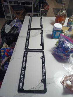 black license plate frames with white lettering are official dealer accessories for the Fort Lauderdale Collection, a luxury and exotic car dealership
