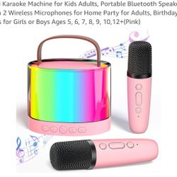 New in box Pink karaoke machine with wireless speaker comes with two microphones 
