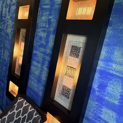 pair of decorative wood wall art panels featuring abstract, textured inserts.