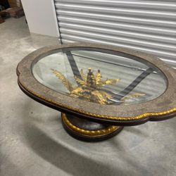 Large glass and metal  coffee table with golden decor in the center .. 5’ feet wide . 39 “ depth, . 23” high .. $400