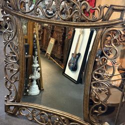 #268 Large ornate gold metal and wood decorative wall mirror 52“ x 44“