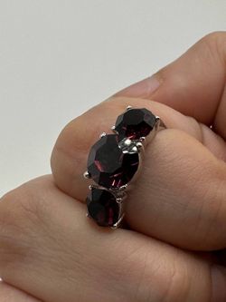 A silver ring with purple cubic zirconia stones: a beautiful design. Excellent quality.