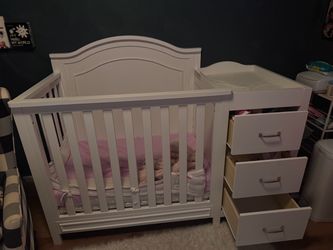 Baby crib with changing table