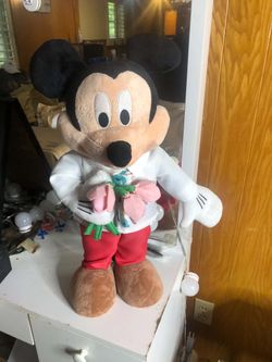 This is a Vintage 24-inch "Visitor with Flowers" Mickey Mouse doll, often marketed for occasions like Valentine's Day