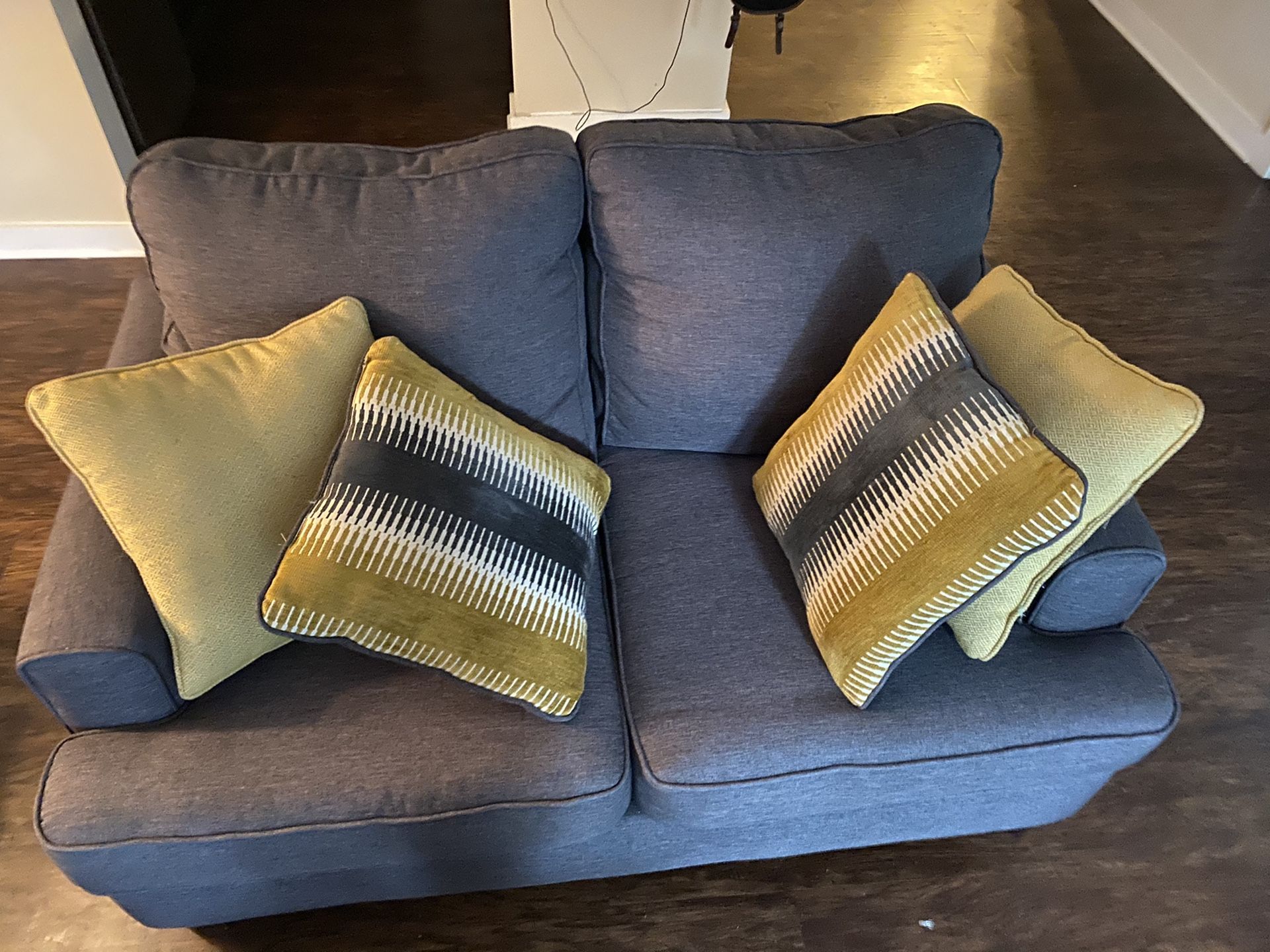 gray/silver love seat couch & yellow accent pillows