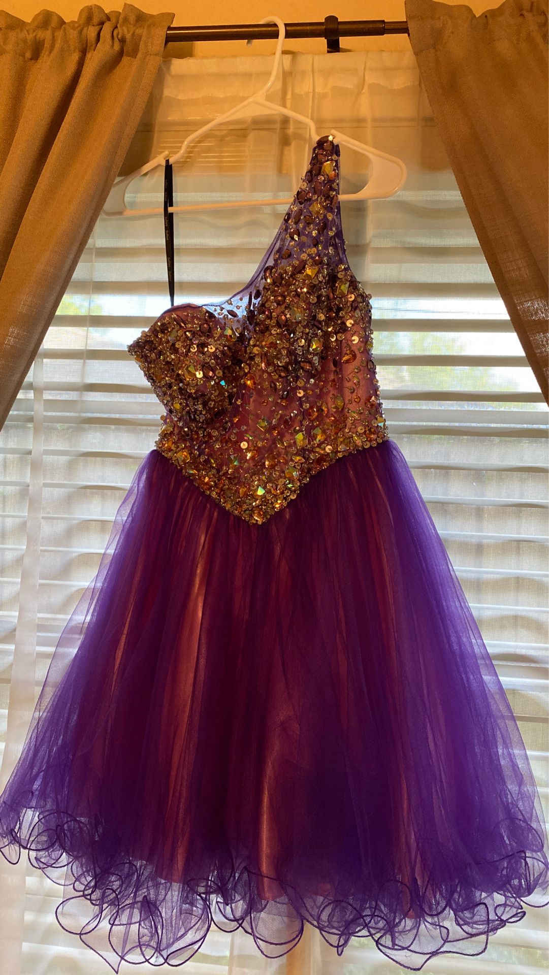 Purple dress with gems and sequencing.