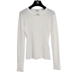 CHANEL long-sleeve top featuring a delicate pointelle knit texture and a small decorative bow detail at the neckline