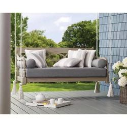 Weathered gray daybed porch swing with gray Sunbrella bottom cushion and 2 round bolster pillows 