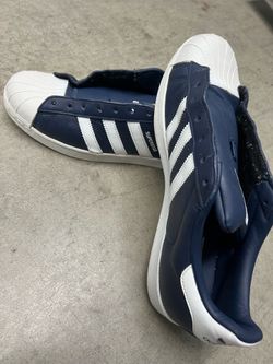 Used Adidas Superstar shoes in a collegiate navy and white colorway.