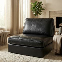 Black Faux Leather Lounge Chair – Modern and versatile, can be used as a standalone chair or as part of a sectional.