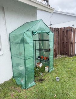2 green houses with shelves $30