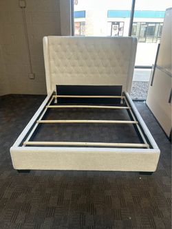 White linen upholstered queen bed frame
