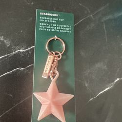 Starbucks reusable hot cup lid stopper with a pink star design.