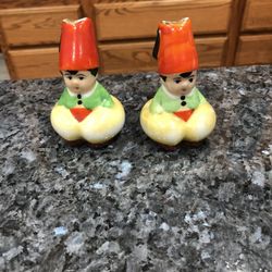 Vintage Porcelain pair of Salt and Pepper Shakers.  No stoppers see pictures.  Size 3 inches.  Made in Japan.  Preowned good condition.  