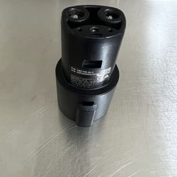 This item is a Tesla SAE J1772 Charging Adapter (Part Number 1067348-00-C),