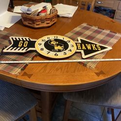 Iowa Hawkeyes metal distress wall clock incredible bold colors approximately 26” in length approximately 11” tall at center point Hook on back for eas