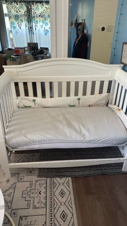 Delta - Baby crib with mattress.