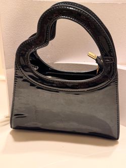 Black patent leather heart-shaped handbag with gold hardware #handbag #designer