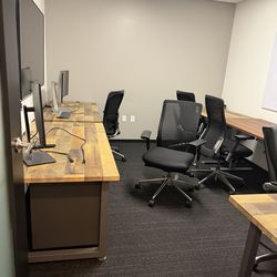 Office desks, monitors, conference table, chairs