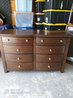 Brown 8 drawer dresser with curved front and mirror