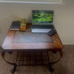 Elegant wooden coffee table with metal legs and lower grid shelf.