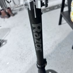 Scooter-black With Red Wheels.