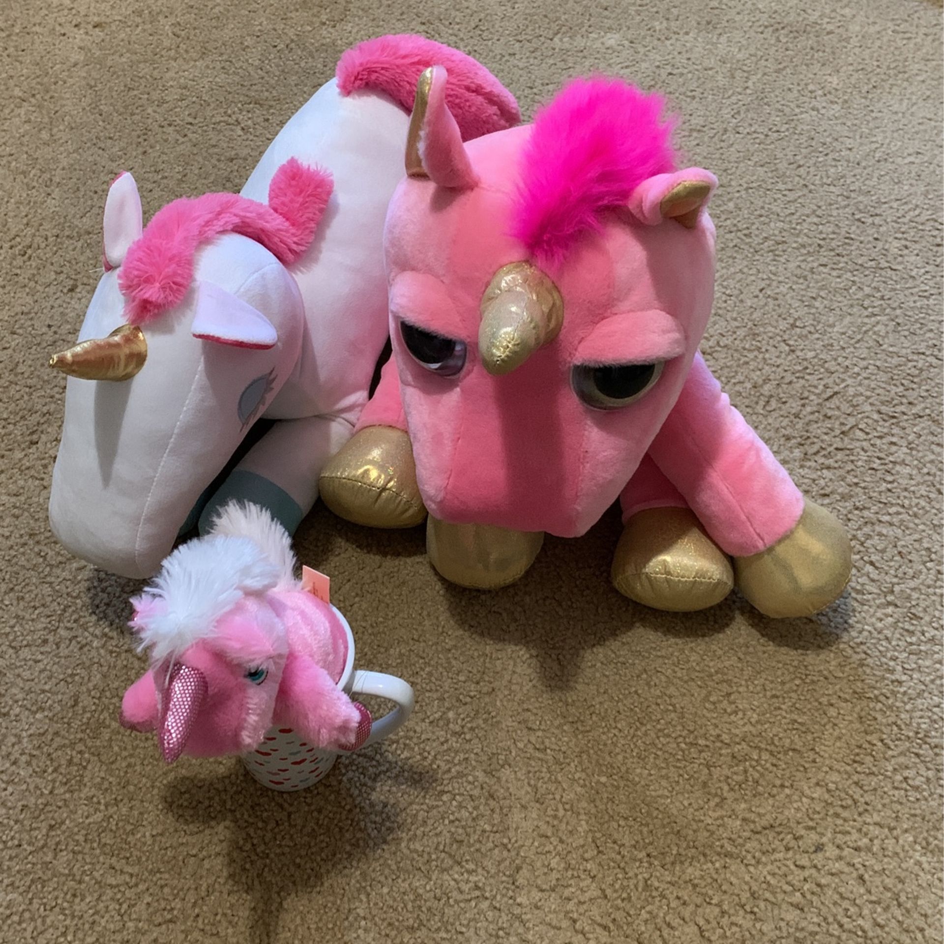 Stuffed unicorns and one miniature unicorn In a coffee mug brand new