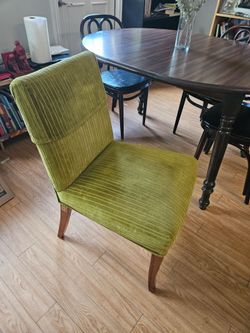 Two green soft cushion designer chairs
