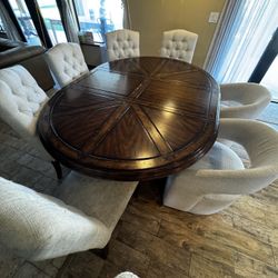 7-piece dining set including table, 5 dining chairs, and 2 rolling/swivel armchairs.