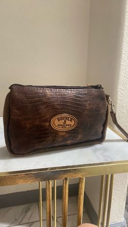 brown leather zippered pouch by Double J Saddlery features an autumn crocodile print