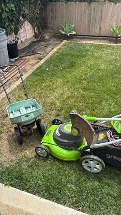 Complete electric lawn care setup — Greenworks mower, trimmer, edger, plus Scotts fertilizer spreader. Everything works great