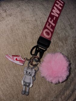 keychain set with sneaker, figure, and pom pom