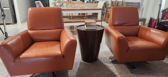 Two brand new Orange Leather Swivel Accent Chair..