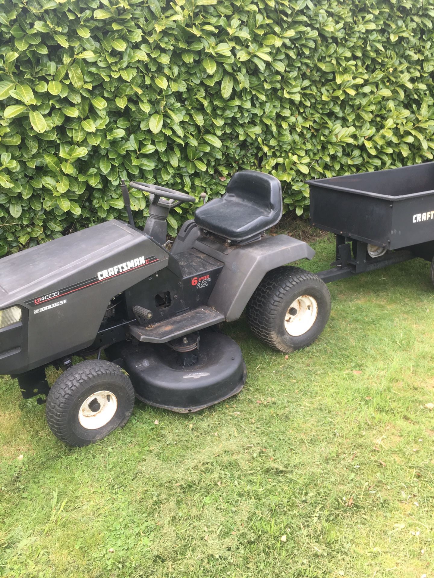 Craftsman riding lawn mower with blade and utility trailer