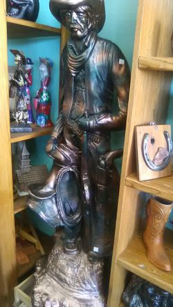 Sculpture of cowboy with rope and gun 46" tall