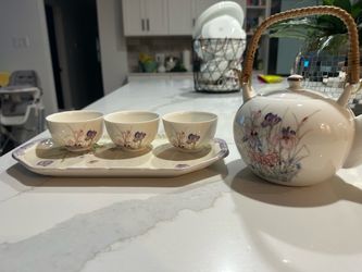 Porcelain serving tray with tea cups and pot