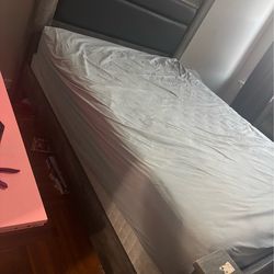 Bedroom set consisting of a bed frame with a headboard, two nightstands, and a dresser—dark gray in color (mattress not included).