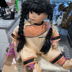 Porcelain oriental doll 15 inches when she’s sitting beautiful detailing don’t miss out