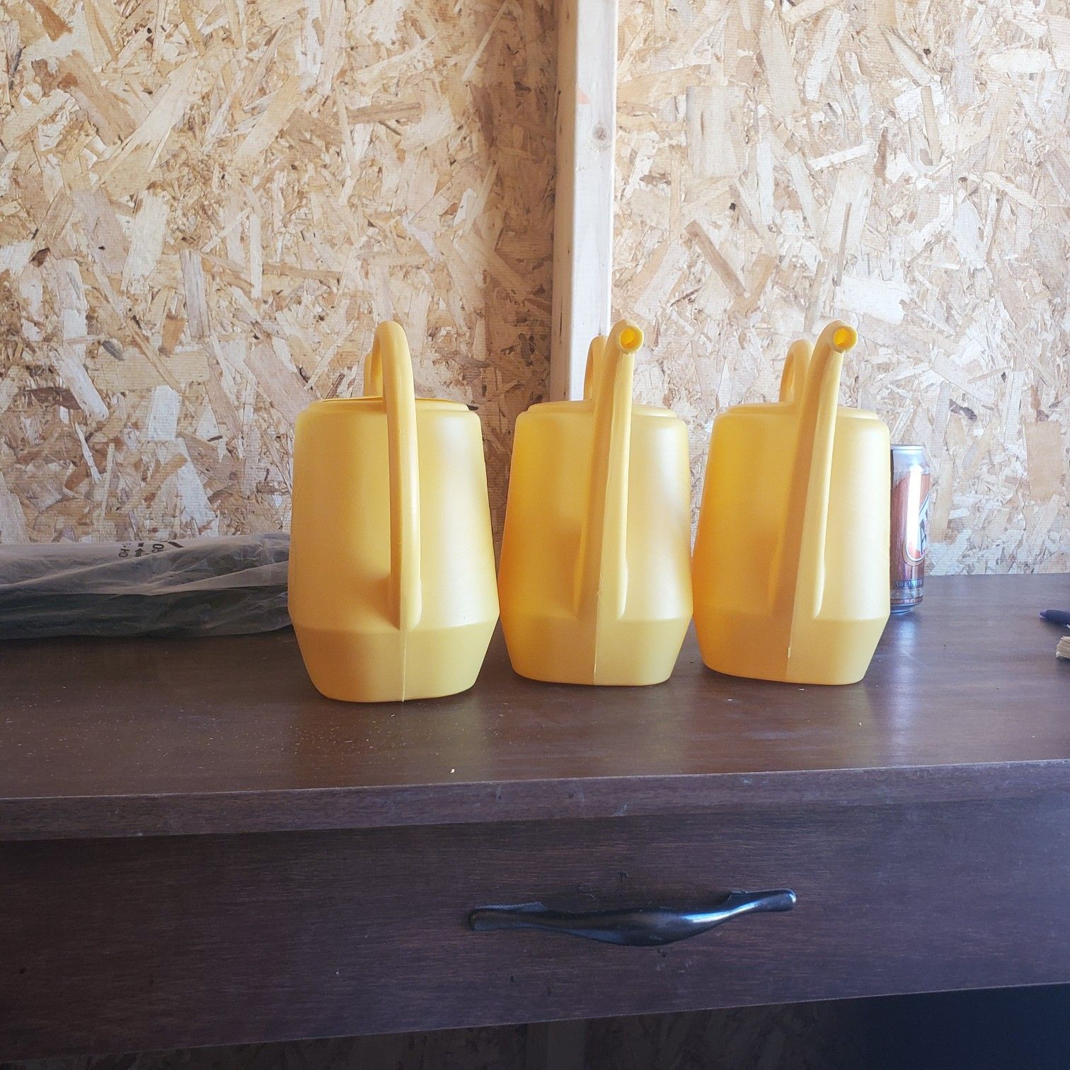 Yellow plastic watering cans