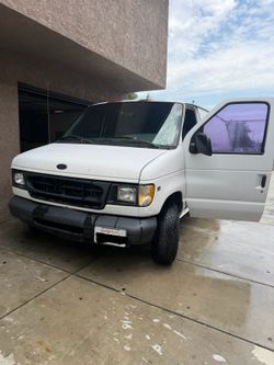 A white 1998 Ford Econoline 150