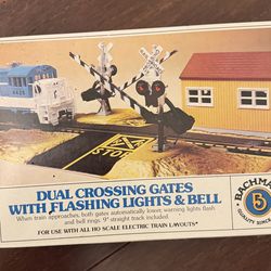 DUAL CROSSING GATES WITH FLASHING LIGHTS & BELL When train approaches, both gates automatically lower, warning lights flash and bell rings. 9" straigh