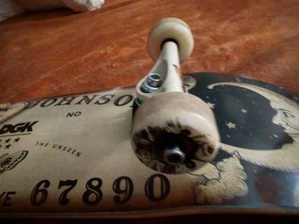This is a DGK Boo Johnson All Night skateboard deck Venture skateboard trucks are pictured featuring bright green bushings.