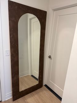 Full mirror on wood.