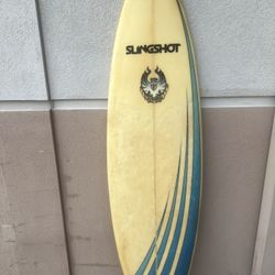 6fVintage Slingshot surfboard W/ Cannibal graphic. Used in good condition with some areas of patches. Despite the patches the top is  still in great c