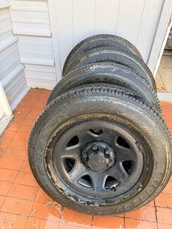 Bridgestone Dueler H/T tires mounted on black Chevrolet 6-lug wheels. Tires are size P255/70R17