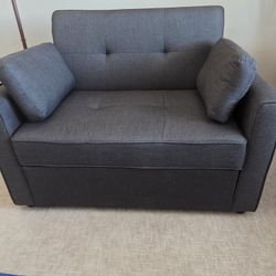 Dark Grey Fabric Chair That Serves as A Twin Bed.