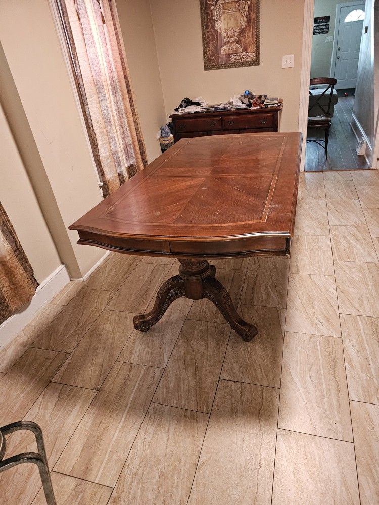 Antique maple drop Solid wood dining room table With no chairs.