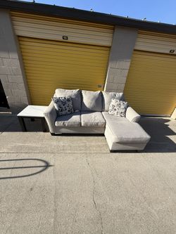 Ashley Furniture Reversible Sectional W/ End Table. $400. Will Deliver For A Fee.