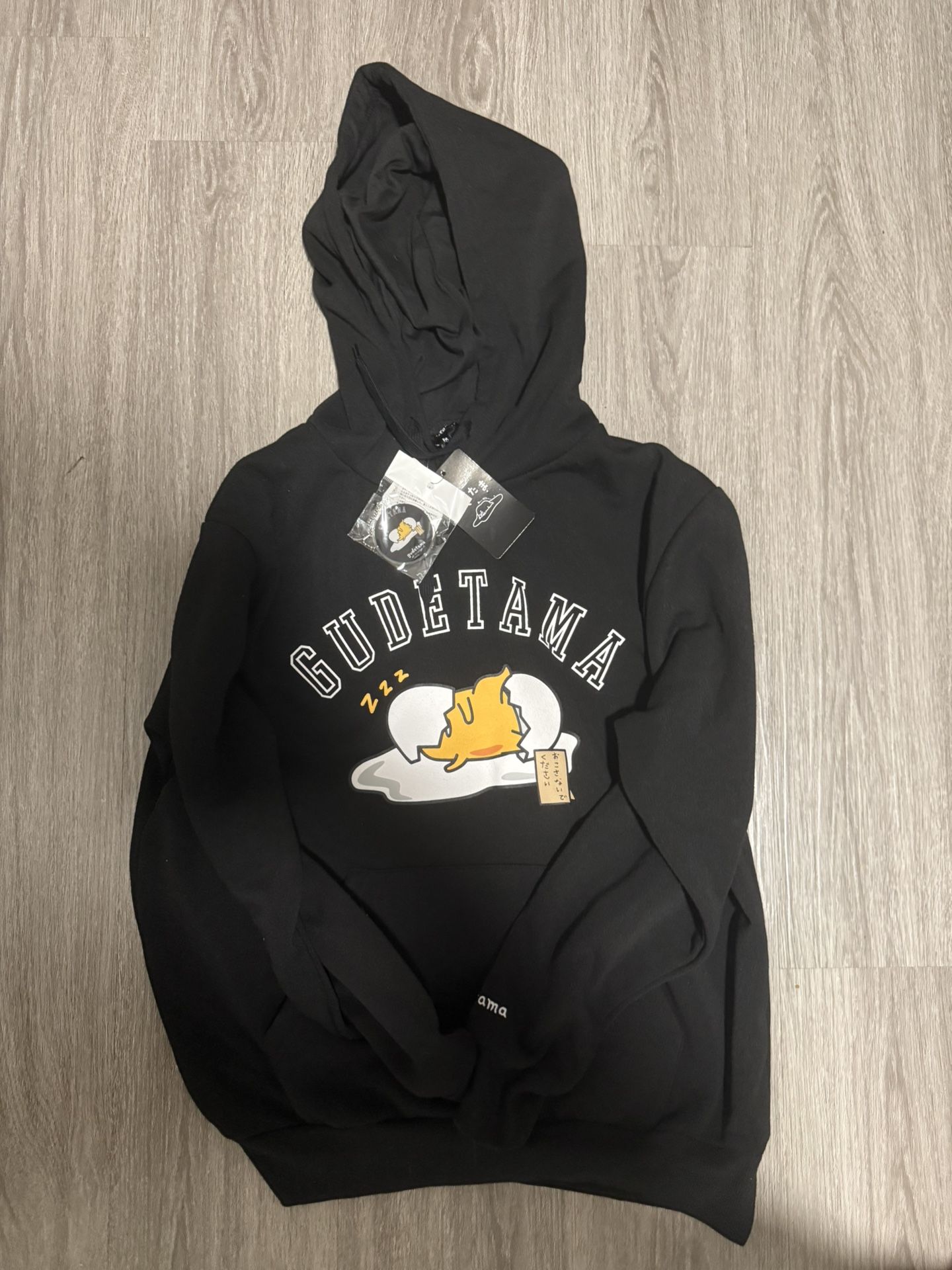 black gudetama hoodie with yellow accents